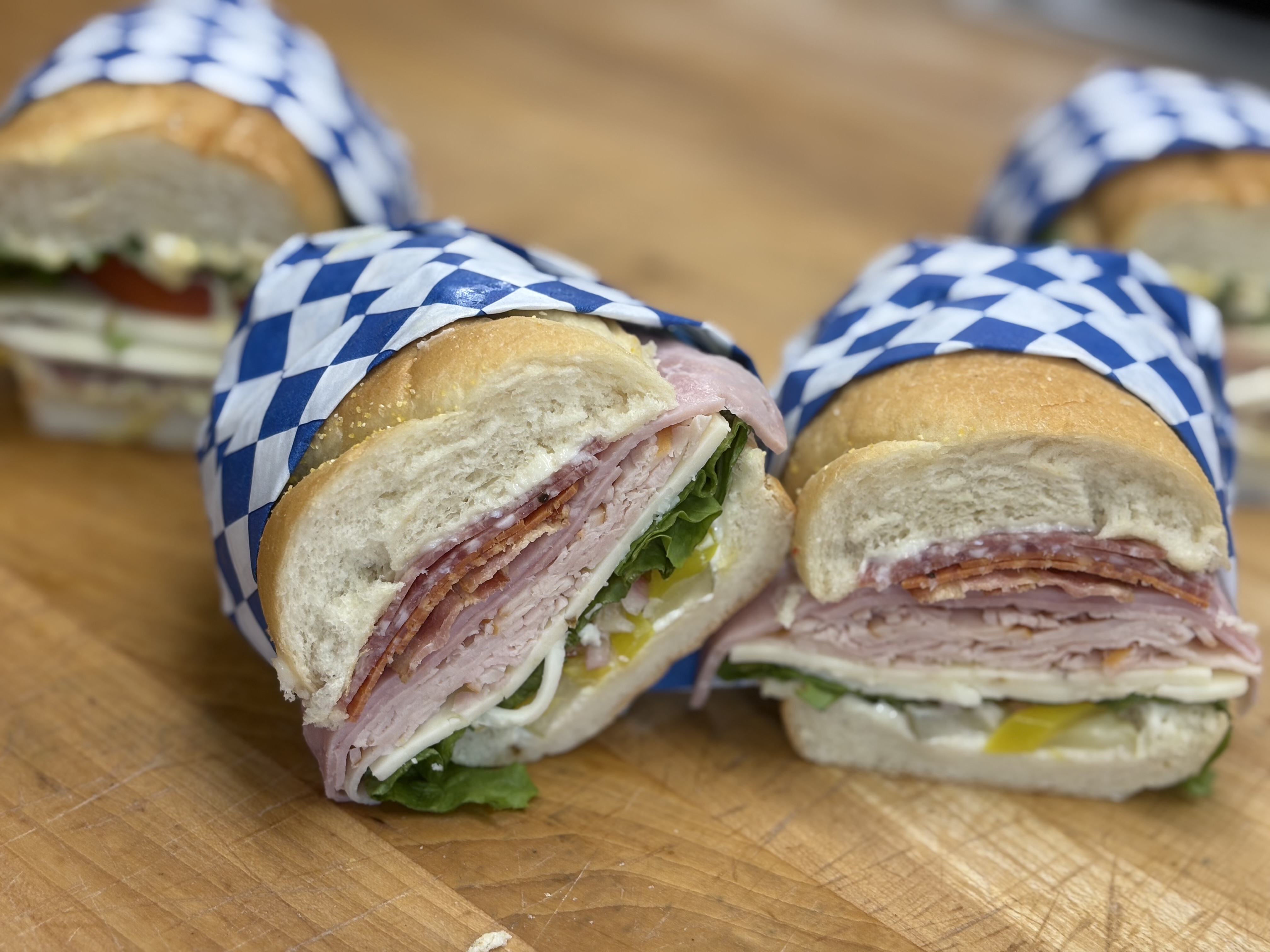 Fresh Clear Creek Market deli sandwiches wrapped in blue checkered paper